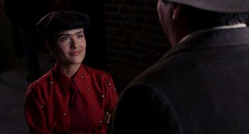 Movie still from “Frida” (2002), directed by Julie Taymor – A woman in a red shirt and a man in a black hat; Close Up shot, Over the shoulder angle