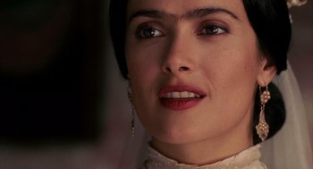 Movie still from “Frida” (2002), directed by Julie Taymor – A person wearing a white shirt and a necklace; Close Up shot, Over the shoulder angle
