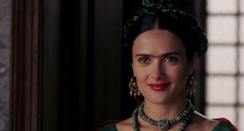 Movie still from “Frida” (2002), directed by Julie Taymor – A person wearing a necklace and earrings; Close Up shot, Over the shoulder angle