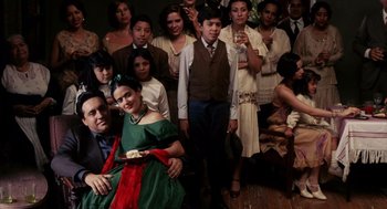 Movie still from “Frida” (2002), directed by Julie Taymor – A group of young people posing for a picture; Wide shot, Overhead angle