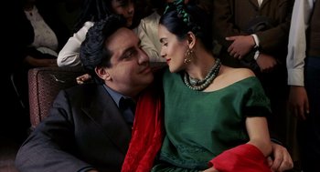 Movie still from “Frida” (2002), directed by Julie Taymor – A man and a woman sitting next to each other; Close Up shot, Overhead angle