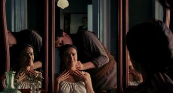 Movie still from “Frida” (2002), directed by Julie Taymor – A man and a woman in front of a bathroom mirror; Close Up shot, Over the shoulder angle