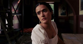 Movie still from “Frida” (2002), directed by Julie Taymor – A woman in a white shirt is sitting down; Close Up shot, Low angle