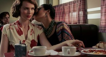 Movie still from “Frida” (2002), directed by Julie Taymor – Two women sitting at a table with cups of coffee; Close Up shot, Over the shoulder angle