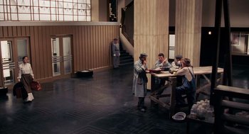 Movie still from “Frida” (2002), directed by Julie Taymor – A group of people sitting at a table in a room; Wide shot, High angle