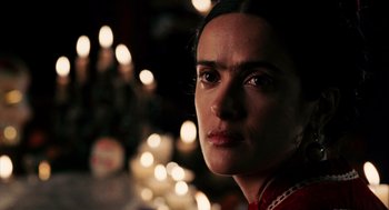 Movie still from “Frida” (2002), directed by Julie Taymor – A person wearing a red shirt; Close Up shot, Over the shoulder angle