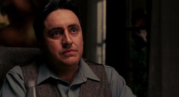 Movie still from “Frida” (2002), directed by Julie Taymor – A person wearing a suit and tie; Close Up shot, Over the shoulder angle