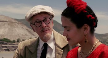 Movie still from “Frida” (2002), directed by Julie Taymor – An older man and a young woman are looking at one another; Close Up shot, Over the shoulder angle