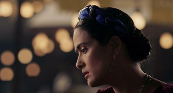 Movie still from “Frida” (2002), directed by Julie Taymor – A person wearing a headband; Close Up shot, Over the shoulder angle