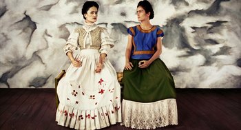 Movie still from “Frida” (2002), directed by Julie Taymor – A painting of two women sitting on a bench; Medium shot, Overhead angle