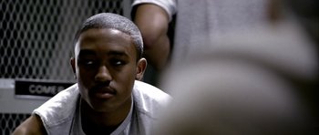 Movie still from “Friday Night Lights” (2004), directed by Peter Berg – A young man sitting in front of another man; Close Up shot, Over the shoulder angle