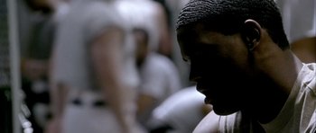 Movie still from “Friday Night Lights” (2004), directed by Peter Berg – A person's face in a crowd; Close Up shot, High angle