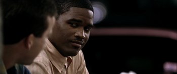 Movie still from “Friday Night Lights” (2004), directed by Peter Berg – A person wearing a shirt and tie; Close Up shot, Over the shoulder angle