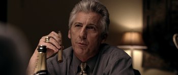 Movie still from “Friday Night Lights” (2004), directed by Peter Berg – An older man holding a wooden stick in his hand; Close Up shot, Over the shoulder angle