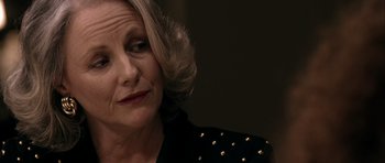 Movie still from “Friday Night Lights” (2004), directed by Peter Berg – An older woman with blonde hair wearing a black jacket; Close Up shot, Over the shoulder angle