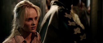 Movie still from “Friday Night Lights” (2004), directed by Peter Berg – A woman with blonde hair standing in front of a man; Close Up shot, Over the shoulder angle