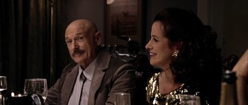 Movie still from “Friday Night Lights” (2004), directed by Peter Berg – An older man and a younger woman sitting next to each other; Close Up shot, Over the shoulder angle