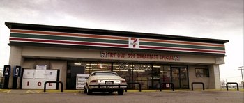 Movie still from “Friday Night Lights” (2004), directed by Peter Berg – A car parked in front of a 7 - eleven store; Extreme Wide shot, Low angle