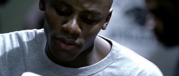 Movie still from “Friday Night Lights” (2004), directed by Peter Berg – A person with his eyes closed; Close Up shot, Low angle