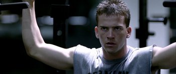 Movie still from “Friday Night Lights” (2004), directed by Peter Berg – A person in a gray t - shirt; Close Up shot, Low angle