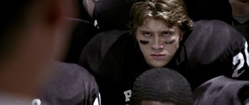 Movie still from “Friday Night Lights” (2004), directed by Peter Berg – A football player's eyes; Close Up shot, Over the shoulder angle