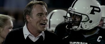 Movie still from “Friday Night Lights” (2004), directed by Peter Berg – An older football coach talking to a player; Close Up shot, Over the shoulder angle