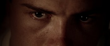 Movie still from “Friday Night Lights” (2004), directed by Peter Berg – A man's eye with a dark background; Extreme Close Up shot, Low angle