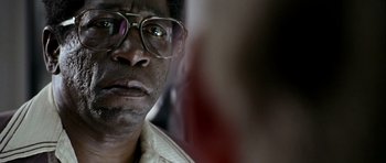 Movie still from “Friday Night Lights” (2004), directed by Peter Berg – A man wearing glasses; Close Up shot, Over the shoulder angle