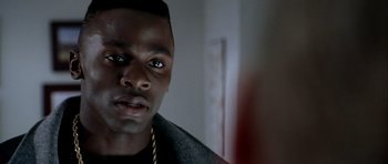 Movie still from “Friday Night Lights” (2004), directed by Peter Berg – A person wearing a black jacket; Close Up shot, Over the shoulder angle