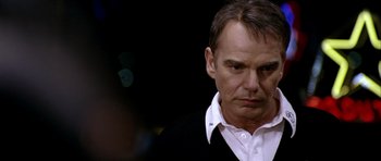 Movie still from “Friday Night Lights” (2004), directed by Peter Berg – A person wearing a white shirt; Close Up shot, Over the shoulder angle