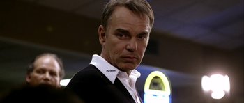 Movie still from “Friday Night Lights” (2004), directed by Peter Berg – A person wearing a suit and tie; Close Up shot, Low angle