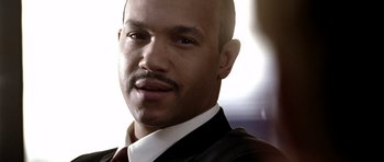 Movie still from “Friday Night Lights” (2004), directed by Peter Berg – A person wearing a suit and tie; Close Up shot, High angle