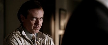 Movie still from “Friday Night Lights” (2004), directed by Peter Berg – A person wearing a suit and tie; Close Up shot, Over the shoulder angle