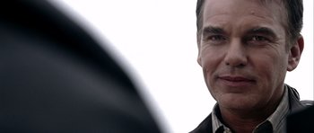 Movie still from “Friday Night Lights” (2004), directed by Peter Berg – A man's face in a black shirt; Close Up shot, Over the shoulder angle