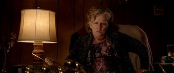 Movie still from “Friday Night Lights” (2004), directed by Peter Berg – An older woman sitting in front of a lamp; Close Up shot, High angle