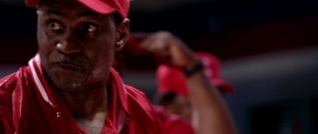Movie still from “Friday Night Lights” (2004), directed by Peter Berg – A man wearing a red hat; Extreme Close Up shot, Low angle