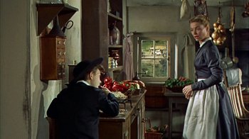 Movie still from “Friendly Persuasion” (1956), directed by William Wyler – Two people in a kitchen with vegetables on the counter; Medium shot, Over the shoulder angle