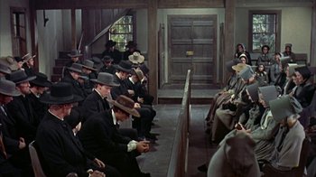 Movie still from “Friendly Persuasion” (1956), directed by William Wyler – A group of men sitting in front of each other; Wide shot, High angle