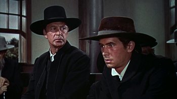 Movie still from “Friendly Persuasion” (1956), directed by William Wyler – Two men in black suits and black hats; Close Up shot, Low angle