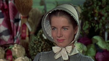 Movie still from “Friendly Persuasion” (1956), directed by William Wyler – A woman wearing a hat and a bow tie; Close Up shot, Low angle