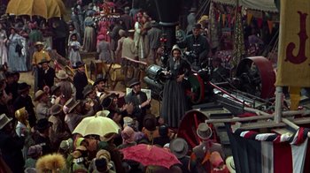 Movie still from “Friendly Persuasion” (1956), directed by William Wyler – A crowd of people gathered in a market area; Wide shot, High angle