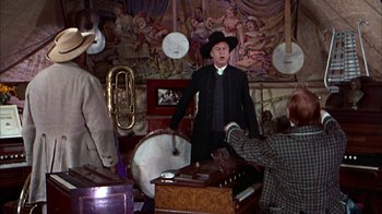 Movie still from “Friendly Persuasion” (1956), directed by William Wyler – A man wearing a black hat and a black suit; Medium shot, Low angle