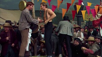 Movie still from “Friendly Persuasion” (1956), directed by William Wyler – Two men are shaking hands in front of a group of people; Medium shot, Low angle