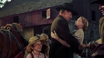 Movie still from “Friendly Persuasion” (1956), directed by William Wyler – A couple of people that are in a barn together; Medium shot, Low angle