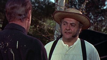 Movie still from “Friendly Persuasion” (1956), directed by William Wyler – A man wearing a straw hat talking to another man; Close Up shot, Over the shoulder angle
