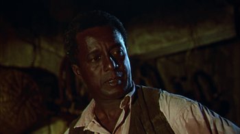 Movie still from “Friendly Persuasion” (1956), directed by William Wyler – A man in a brown vest is looking at the camera; Close Up shot, Low angle