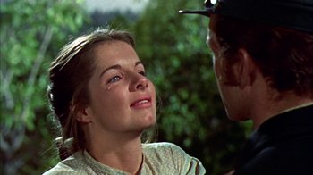 Movie still from “Friendly Persuasion” (1956), directed by William Wyler – A young woman with blue eyes is looking at an older man with blue eyes; Close Up shot, Over the shoulder angle