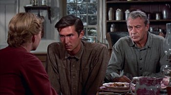 Movie still from “Friendly Persuasion” (1956), directed by William Wyler – A group of people sitting around a table; Medium shot, Over the shoulder angle
