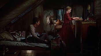 Movie still from “Friendly Persuasion” (1956), directed by William Wyler – A man and a woman sitting on the floor in a room; Wide shot, Low angle