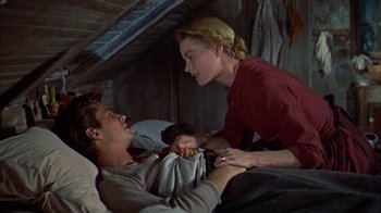 Movie still from “Friendly Persuasion” (1956), directed by William Wyler – A man and a woman are in a bed; Medium shot, Low angle